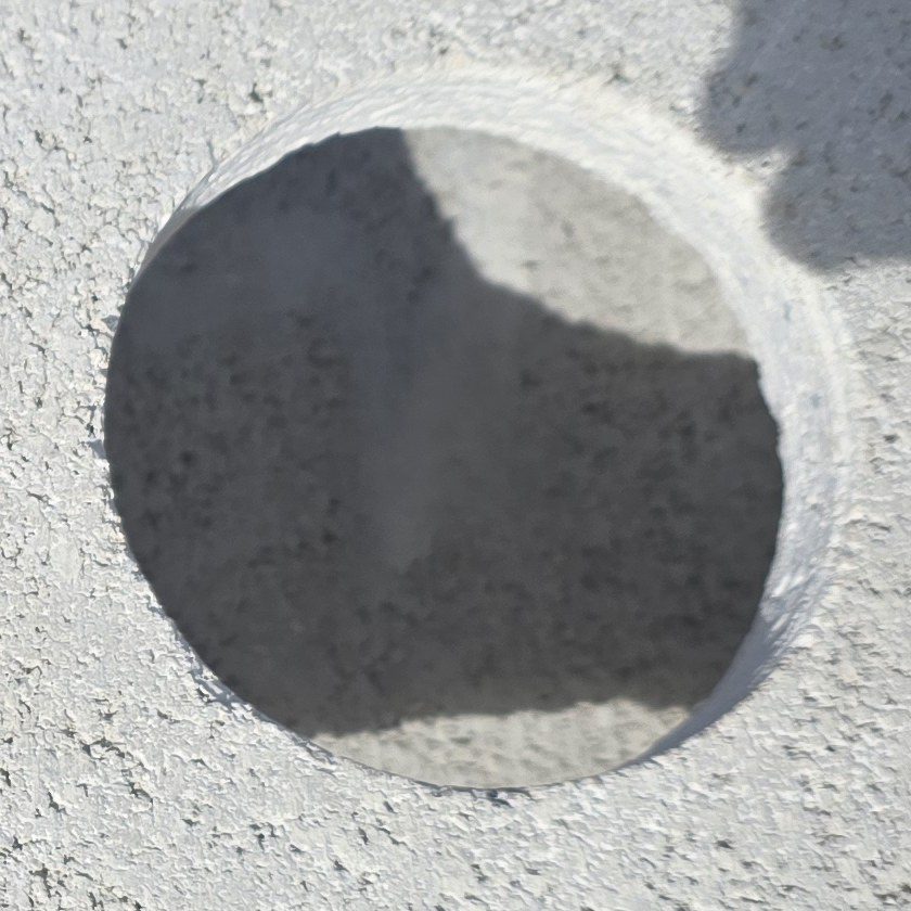 Unprotected drilled hole in stucco